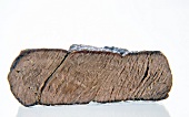 Close-up of well cooked steak fillet on white background