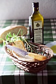 Close-up of olive oil in bottle with bread in basket, Mallorca, Spain