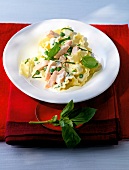 Reginette with salmon and cream sauce on plate