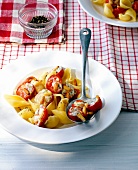 Conchiglie with gorgonzola cheese and tomato on plate and spoon
