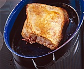 Stuffed veal breast roasted on pan in oil