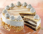 Poppy seed cake with eggnog, flaked almonds and cream rosettes