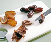 Dates peeled and seeded on cutting board