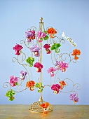 Advent calendar in shape of wire tree with multi-coloured tissue paper flowers
