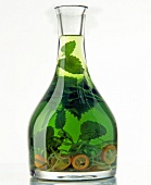 Green oil with citrus and grape-seed in flask