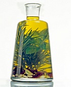 Yellow oil with rosemary and basil in flask