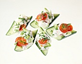 Cottage cheese, tomatoes, green onions and chives on cucumber slices