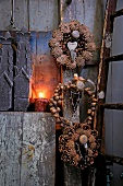 Wreaths of pine cones and acorns hanging on hook