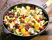 Potato and vegetable stir fry in saute pan