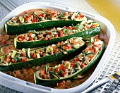 Zucchini with sausage and vegetable filling in serving dish
