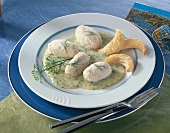 Pike dumplings with dill sauce on plate