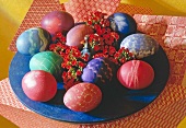 Close-up of colourful painted Easter eggs with red flowers in Asian style
