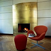 Fireplace with classic furniture and red chair in Elblounge, Blankenese, Hamburg, Germany