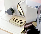 Cutting eggplant slices into bread slicer