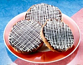 Three American pies with chocolate icing and lattice decoration on plate