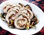 Roast turkey rolls with oyster mushroom stuffing and mushrooms on plate