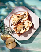 Crisp breads with cottage cheese, apple slices and pumpkin seeds on plate