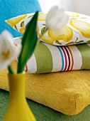 Close-up flower vase with three different types of stacked pillows