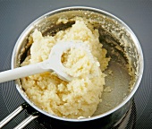 Close-up of semolina being stirred to make dough for dumplings