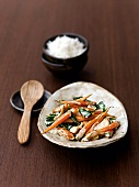 Chicken with stir fried carrots in serving dish
