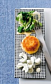 Crab cakes with corn salad and cucumber on tray