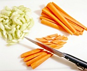 Celery and carrot being sliced to prepare oxtail ragout