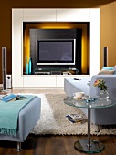 Room with wall unit, TV, sofa and fur carpet