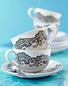 Close-up of white porcelain cups with black pattern