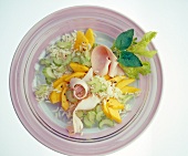 Rice salad with mango, celery and turkey breast on plate