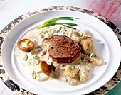 Steak fillet with shiitake sauce and oyster mushrooms on plate