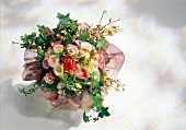 Bouquet of Hepatica, ranunculus and ivy on white background