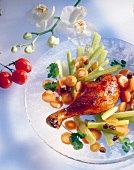 Close-up of chicken leg with vegetables on plate