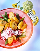 Potatoes with sugar peas, rosemary and radish quark on plate