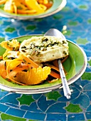 Bakes goat cheese with orange and carrot salad on plate