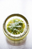 Sauce of honey with vegetable oil, mustard, chopped dill and ground pepper, close-up