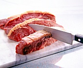 Close-up of rump steaks cut with bucher knife on cutting board