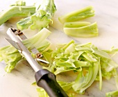 Peeling broccoli stems with vegetable peeler