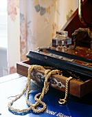 Various gold jewellery in wooden box
