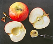 Whole and halved apple with core removed