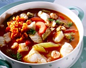 Bowl of fish soup with seafood and chilli paste