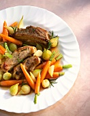 Ribs with carrots, shallots and rosemary on plate