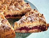 Close-up of crumb cake piece with cherries on plate