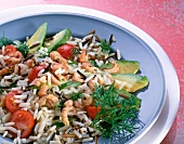 Close-up of wild rice salad with crab, avocado, cherry tomatoes and dill on plate