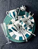Green and white striped plate, cup and saucer with champagne glass and cutlery