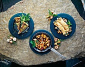 Porcini mushroom pie with chanterelle mushrooms and pancakes on rocky surface