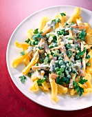 Pasta with vegetables and cheese sauce on plate