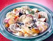 Radish salad with herring fillets and apples in bowl