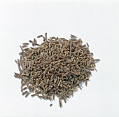 Close-up of black cumin seeds on white background