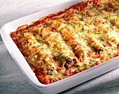 Close-up of cannelloni with tomato and herb sauce and cheese