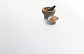 Garam masala in mortar and pestle on white background